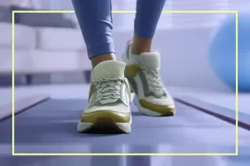 Woman's shoes on walking pad in a home setting