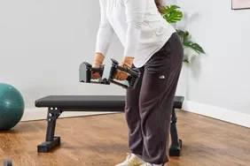 A person lifts the POWERBLOCK Sport 24 Adjustable Dumbbell
