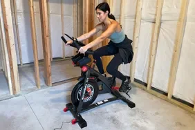Person riding Schwinn IC4 Indoor Cycling Bike in a basement