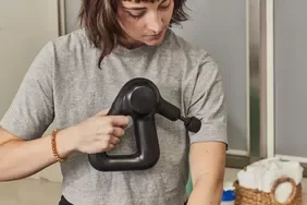 Person using a Therabody Theragun Prime (4th Generation) on their upper arm